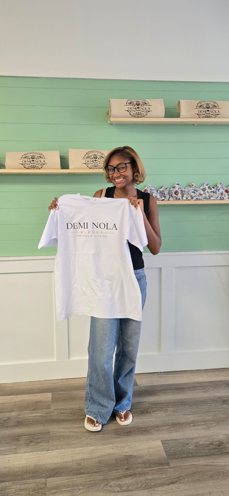Demi Nola Blends merch tee held up inside the Baton Rouge café